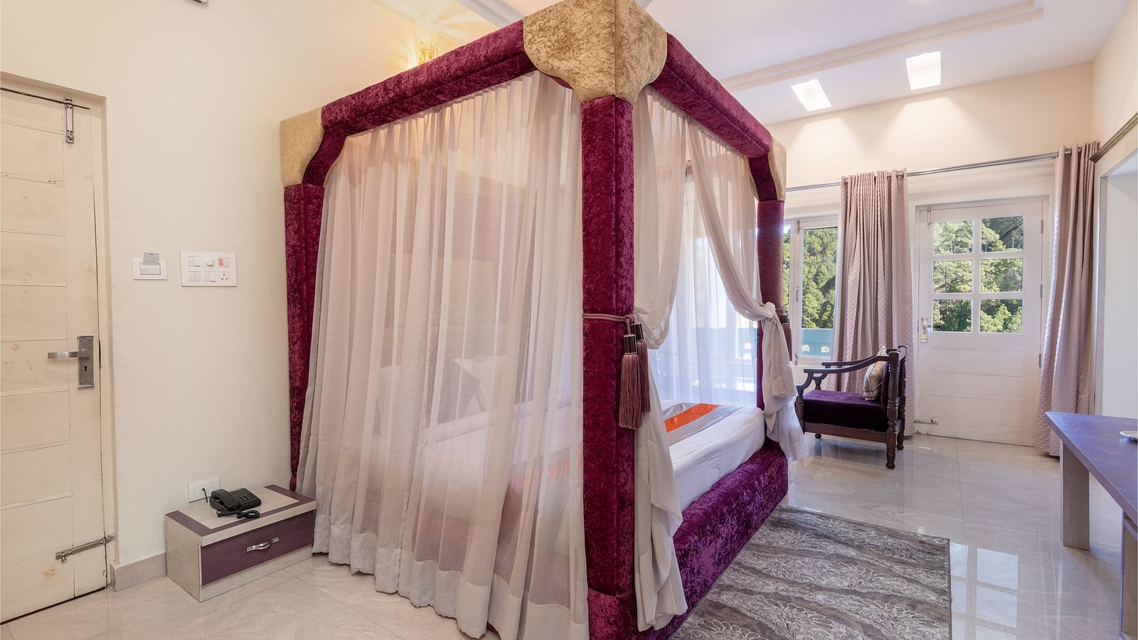King size bed with a canopy in a beautifully decorated room at DLS Tehri Club Resort.